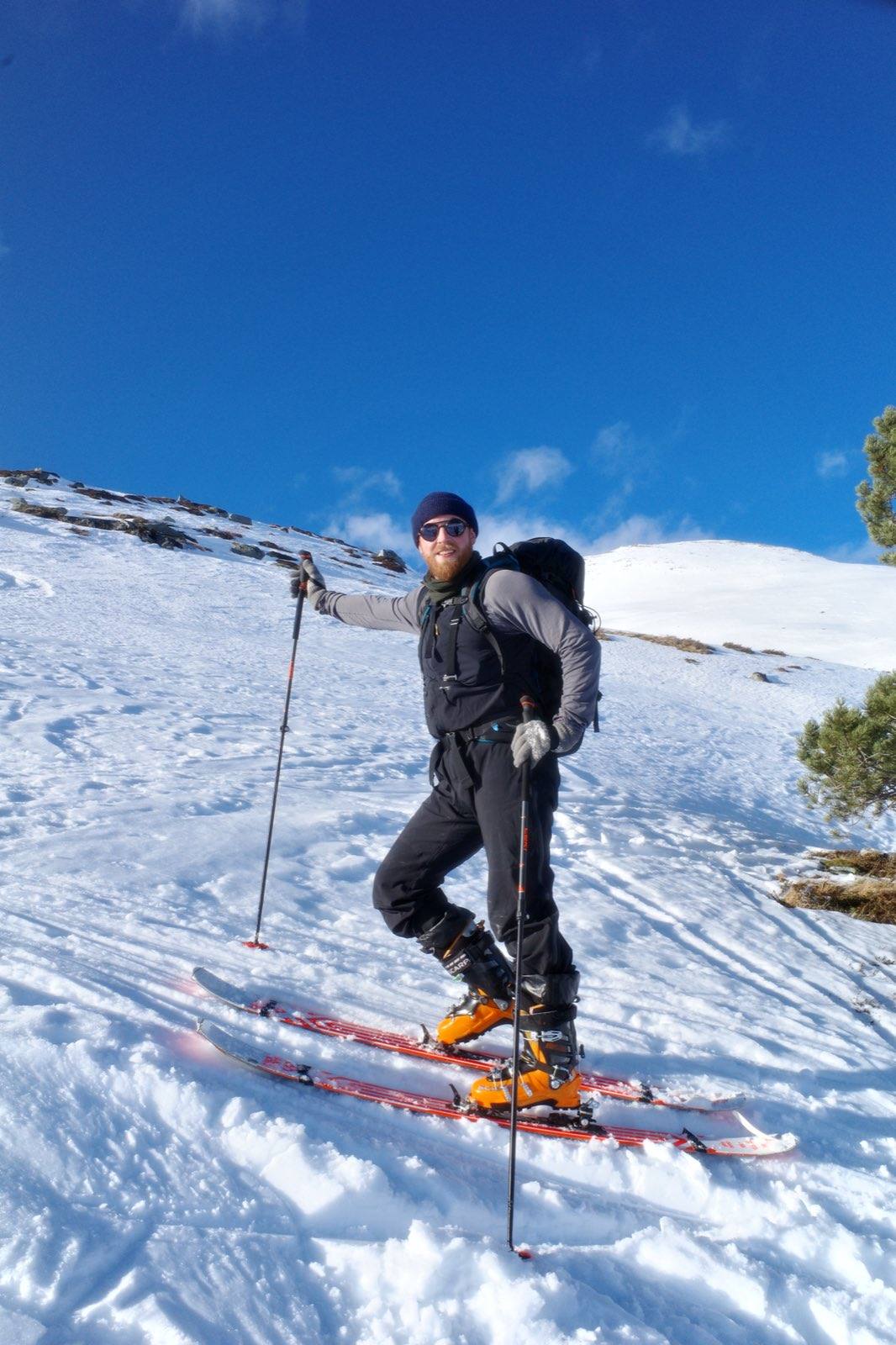 Erlend Brenna Raabe ski touring in the mountains